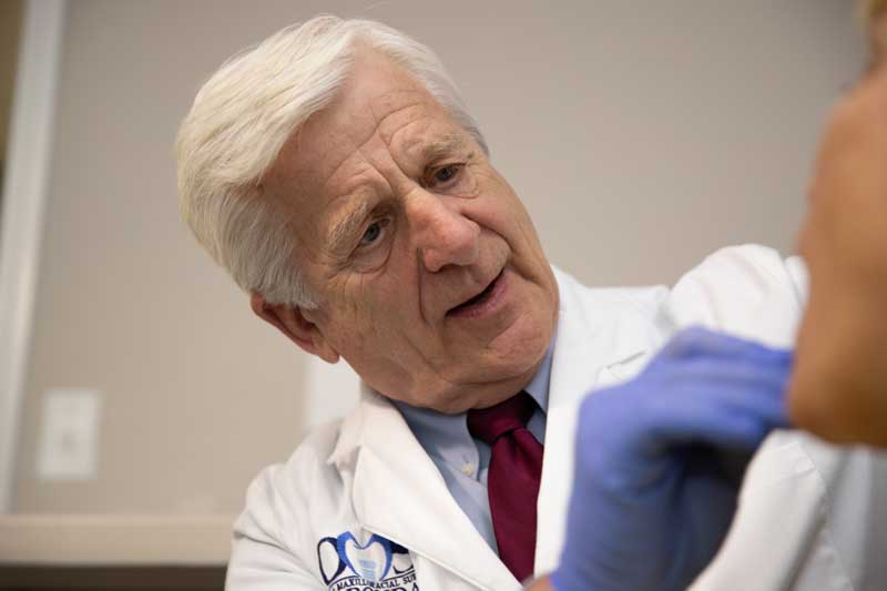 Dr. Gustave working on a patient with failing dental implants