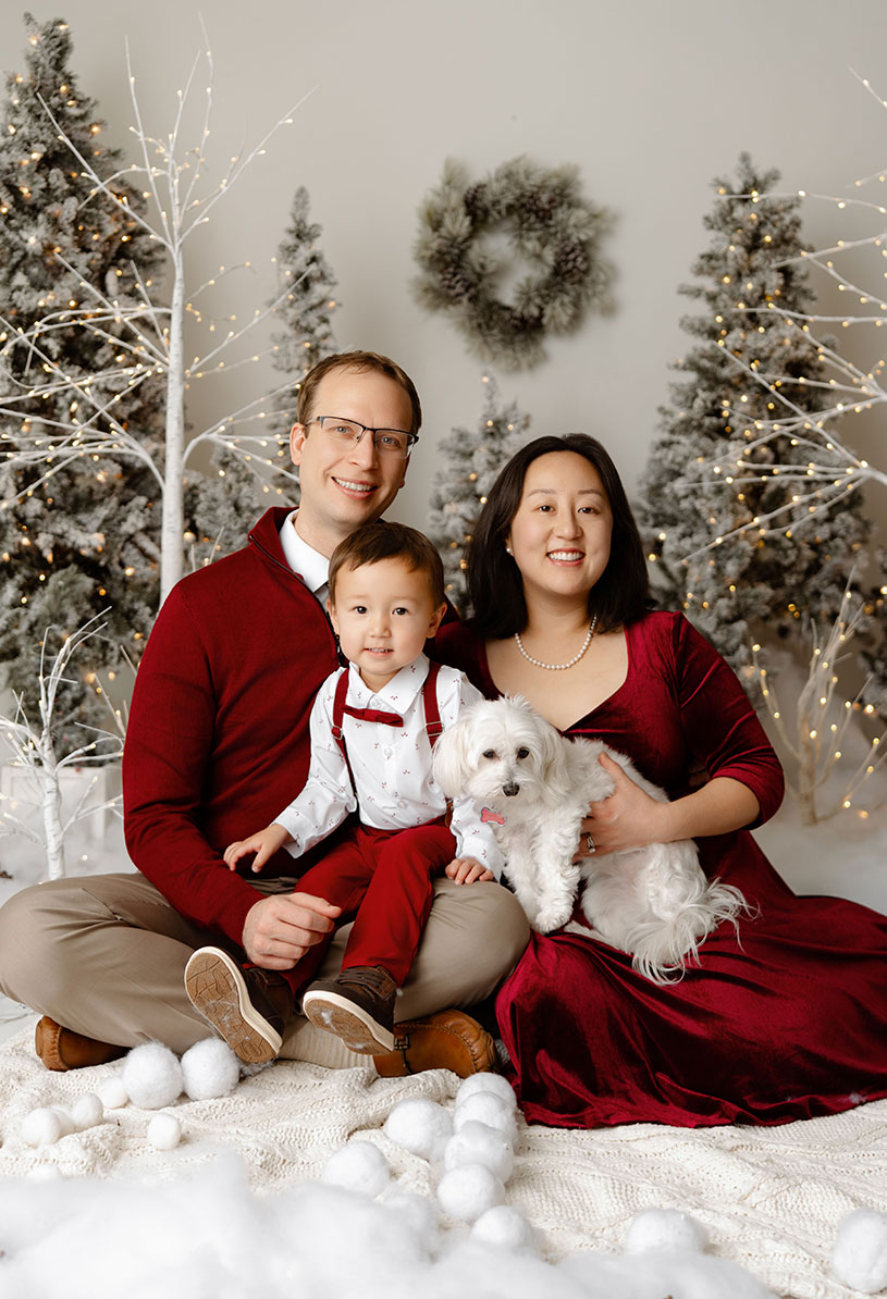 family photo of doctor smiling brightly with their family