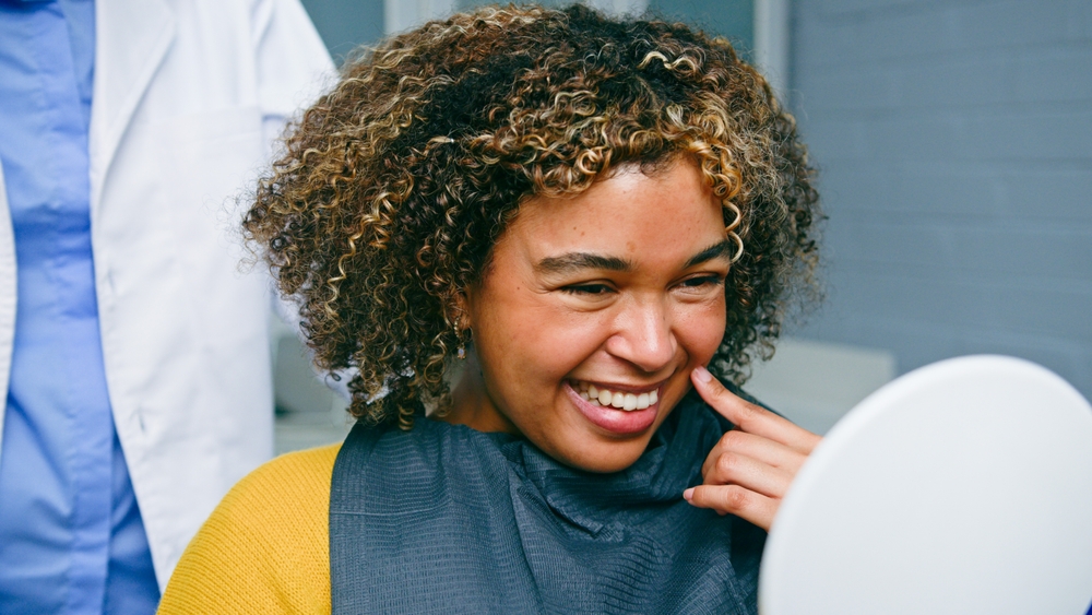 A teenager grimaces, holding their jaw in discomfort, with a faint outline of wisdom teeth erupting in the background. The image should evoke empathy and highlight the common discomfort associated with "wisdom teeth coming in". No text on image.