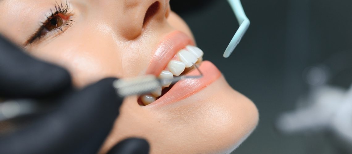 Dentist and dental props working in a dental office, dental props and dentist posing for a photo.